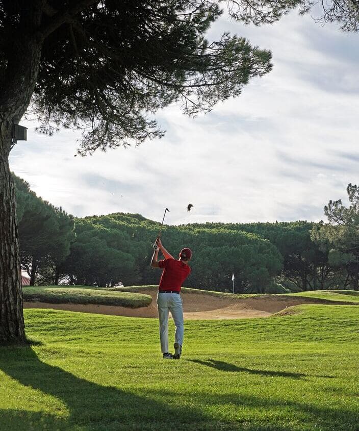 Golf player hitting an approach shot at Quinta da Marinha, Cascais, Portugal